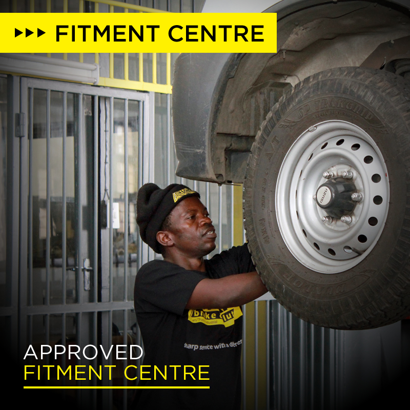 Approved fitment centre with man working on vehicle fitment
