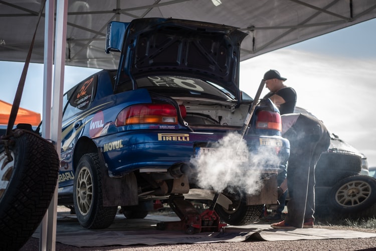 Auto mechanic working on car repairs in a workshop