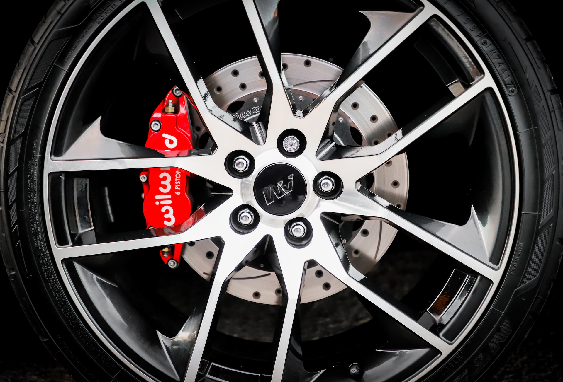 Tire with red brake callipers behind the rim