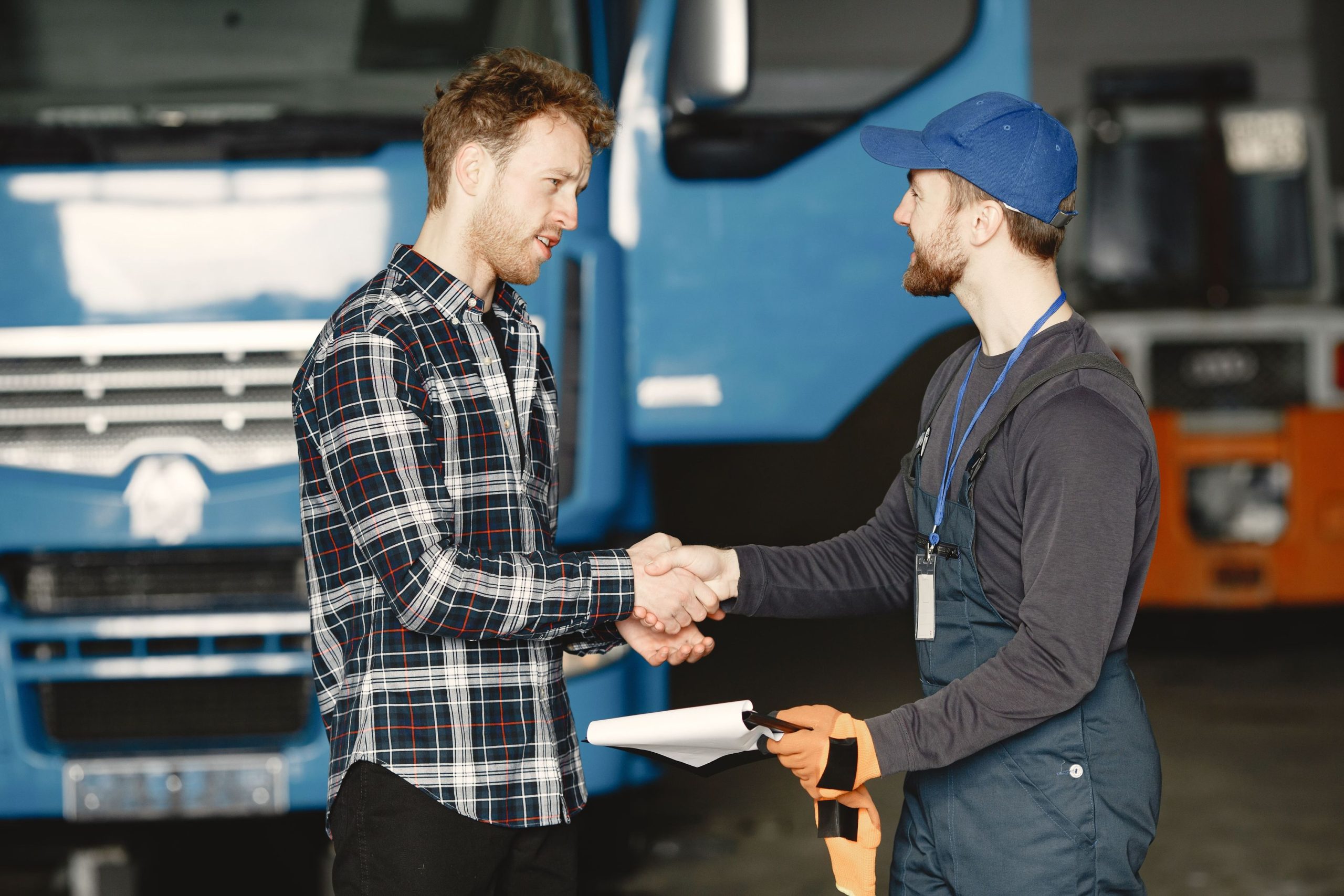 A fleet manager shaking the hands of a mechanic after a professional air brake service